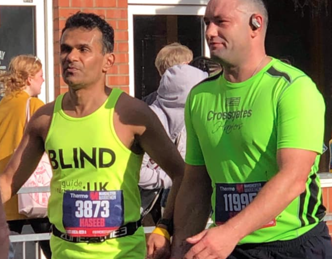 A complete stranger helped a blind runner cross the Manchester Marathon finish line, The Manc