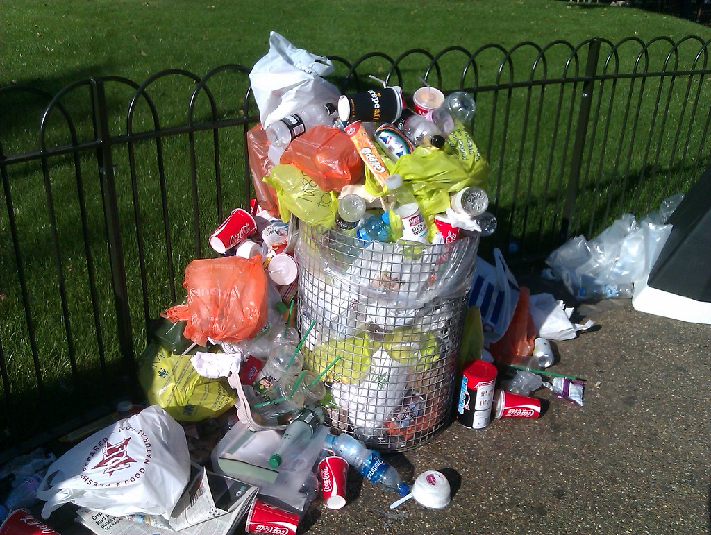 A bin overflowing with rubbish.