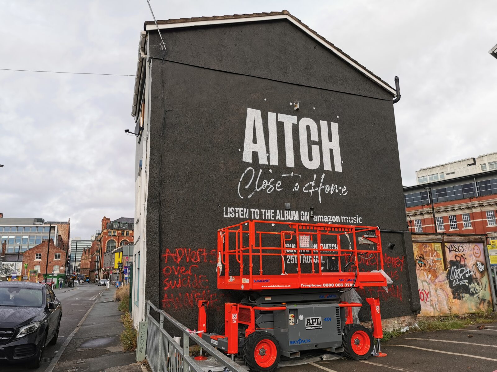 Angry red graffiti has already covered the wall in the Northern Quarter. 