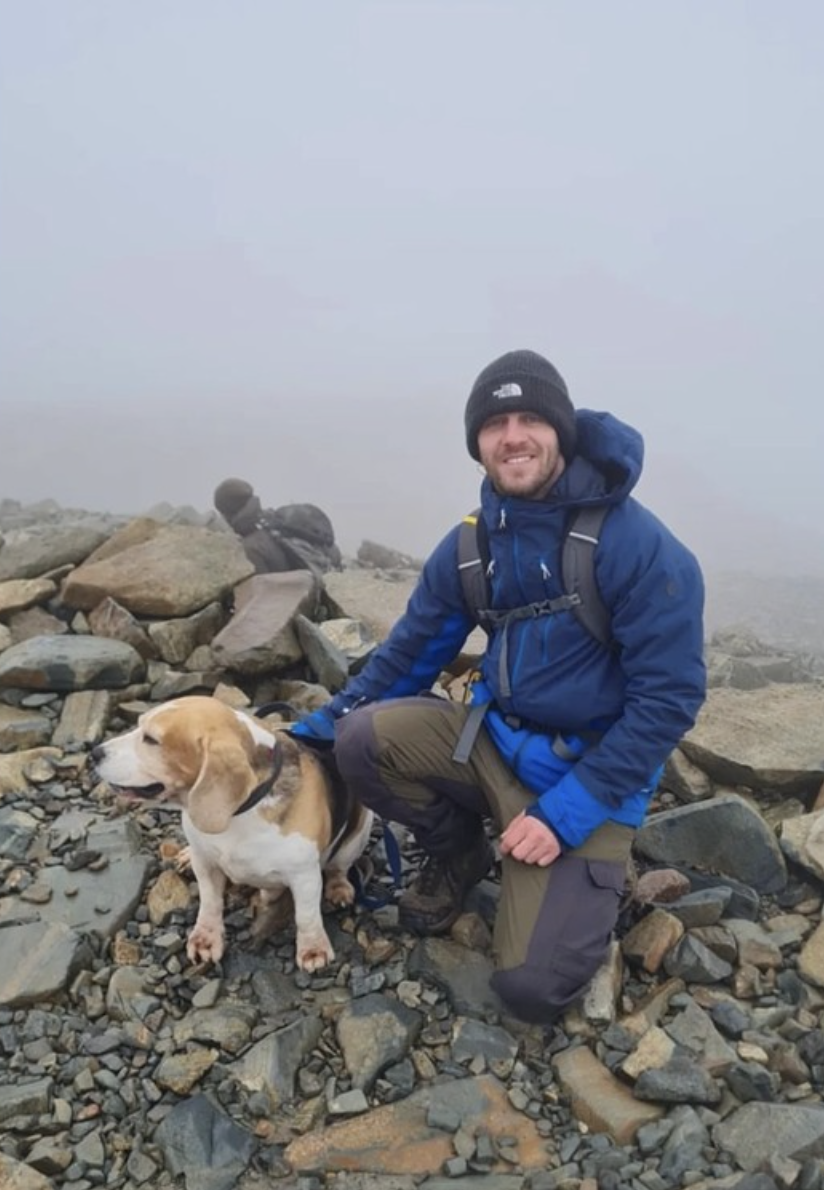 Kyle Sambrook with his dog, a beagle named Bane