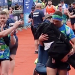 Kevin Sinfield carries Rob Burrow over the finish line at Leeds Marathon