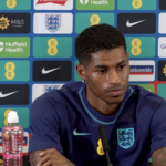 Marcus Rashford reacts to Man City treble win