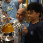 Young Man City fan meets players on the tram treble trophy parade