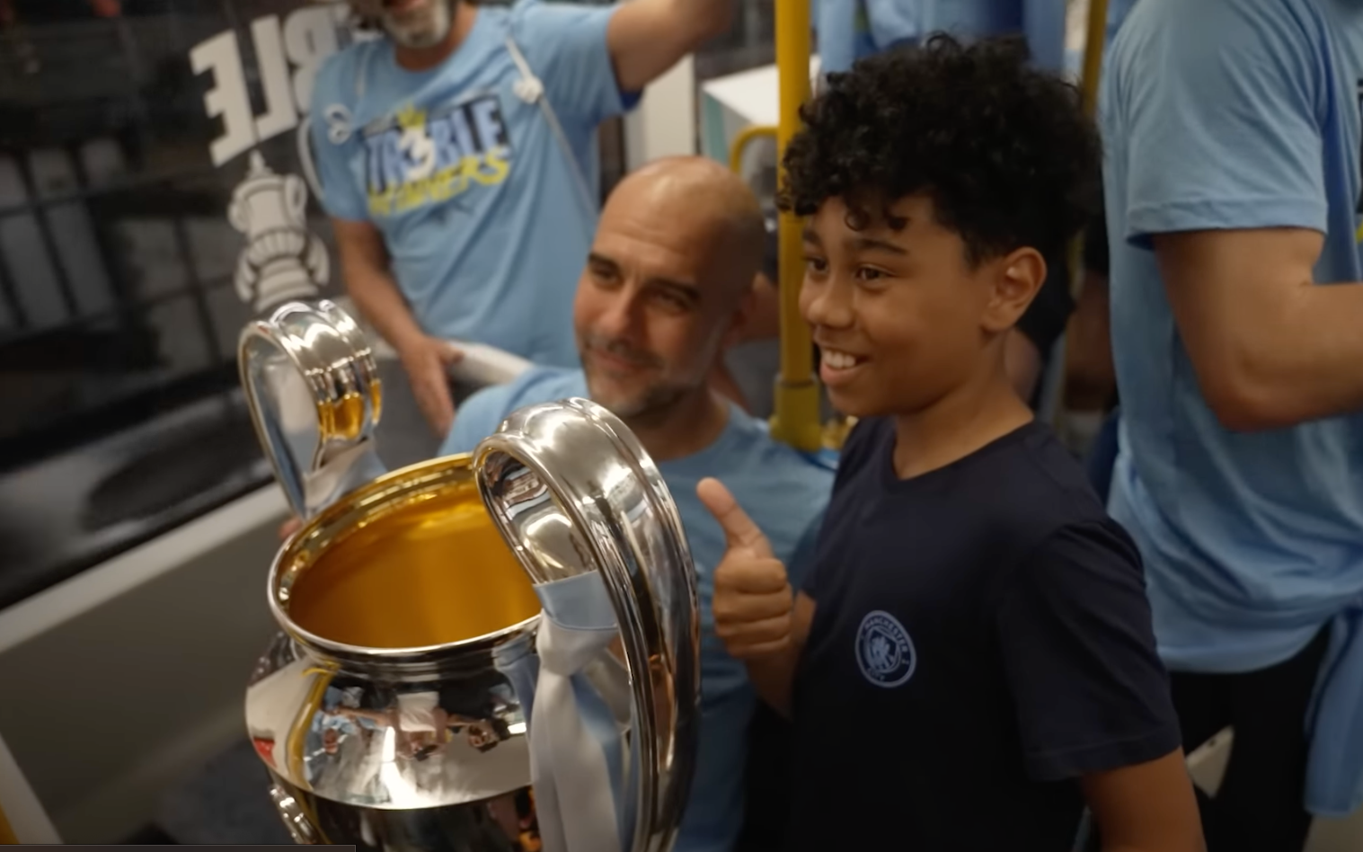 Young Man City fan meets players on the tram treble trophy parade