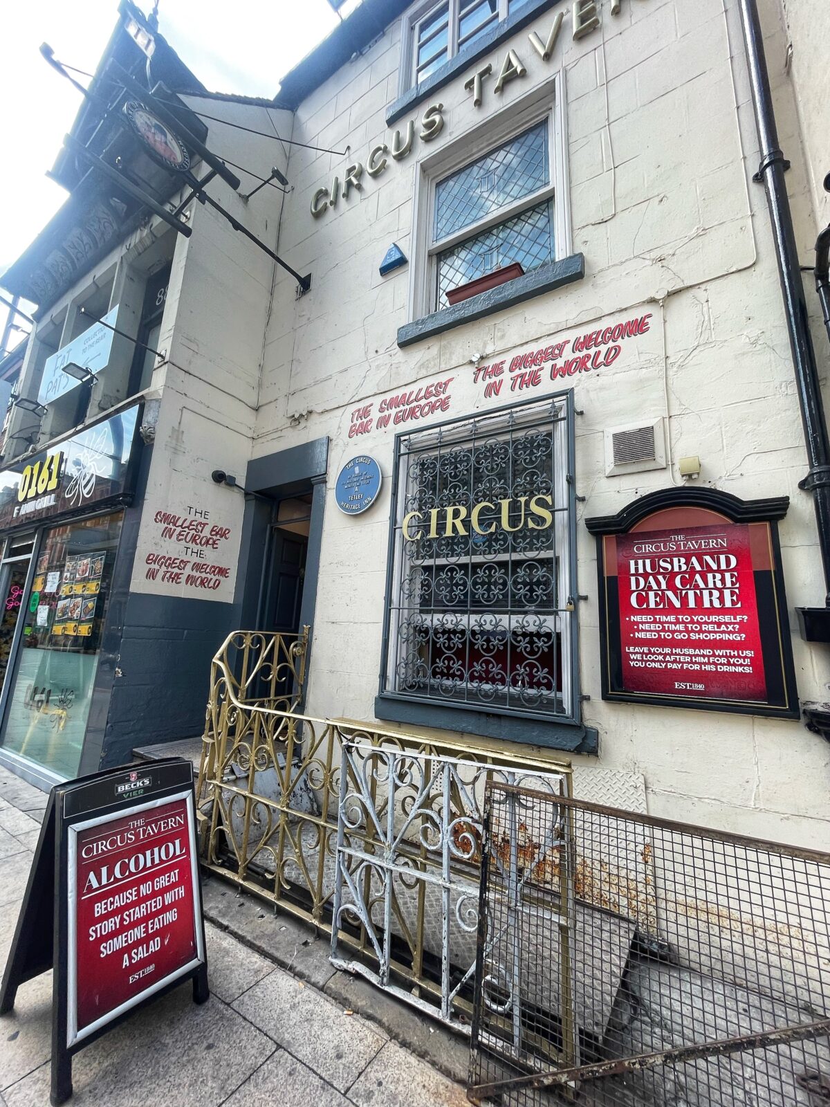 A pub with a sign advertising a husband creche
