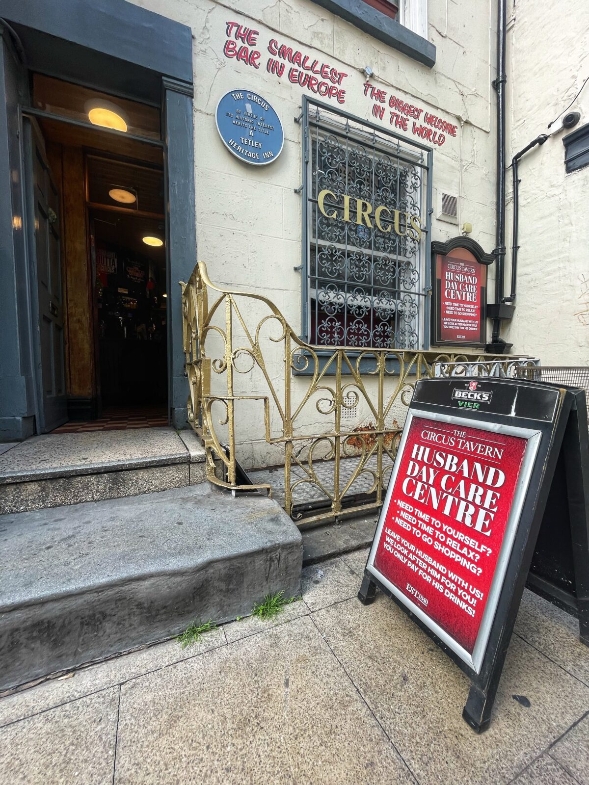 A Manchester pub with a sign advertising a husband creche