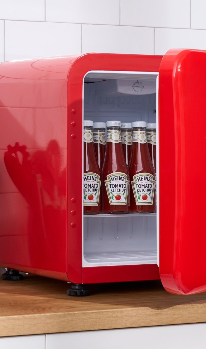 bottles of ketchup in a red fridge.