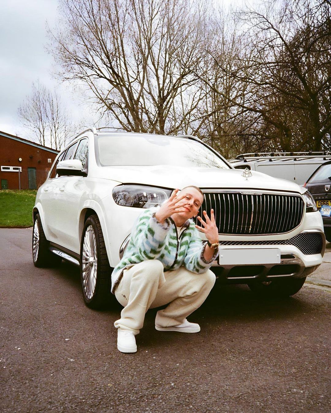 Aitch posing with his luxury Mercedes Maybach car before the attempted break-in.