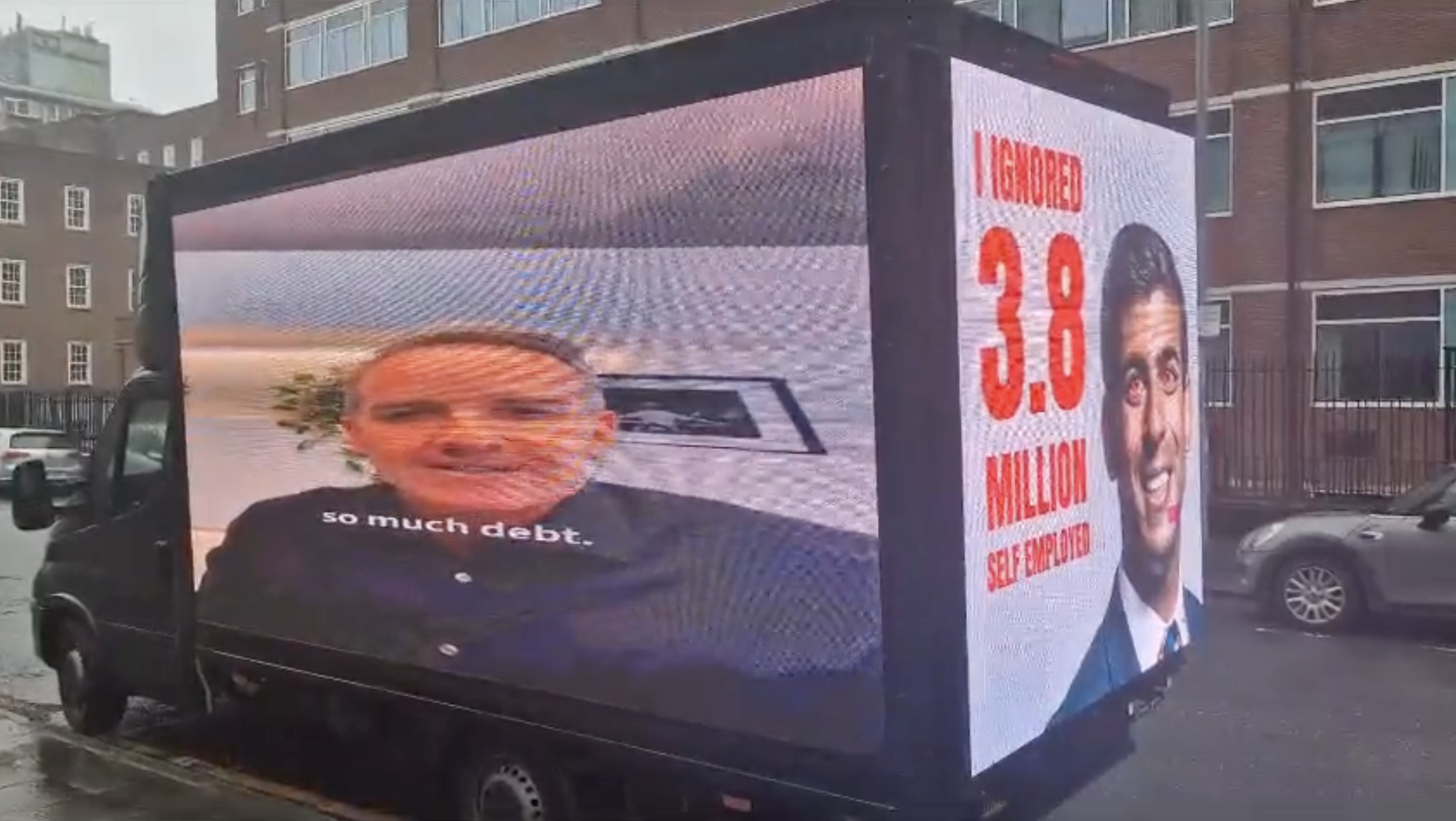 Digital trucks driving loops around the Tory Conference also show the adverts