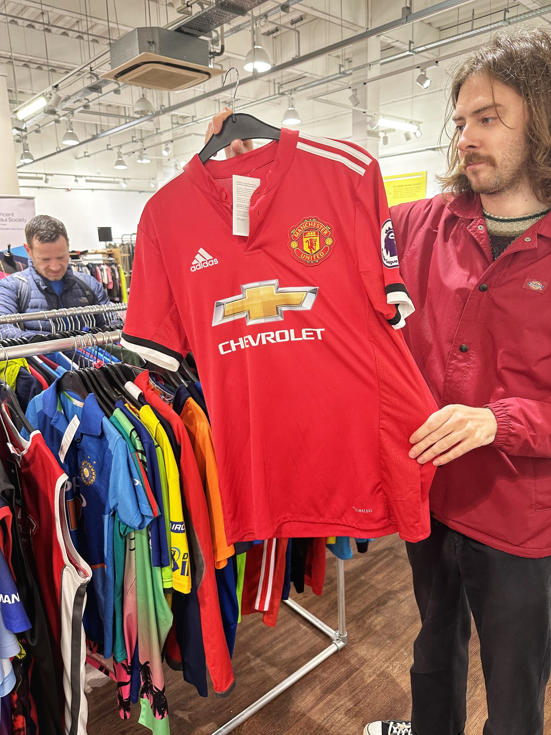 A rail of retro football shirts