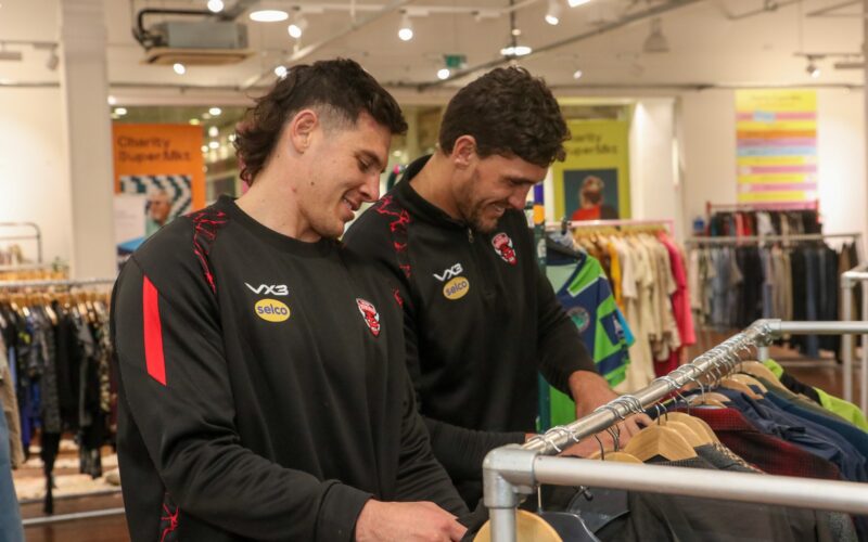 Salford Red Devils donate club kits to Charity Super.Mkt shop in Media City