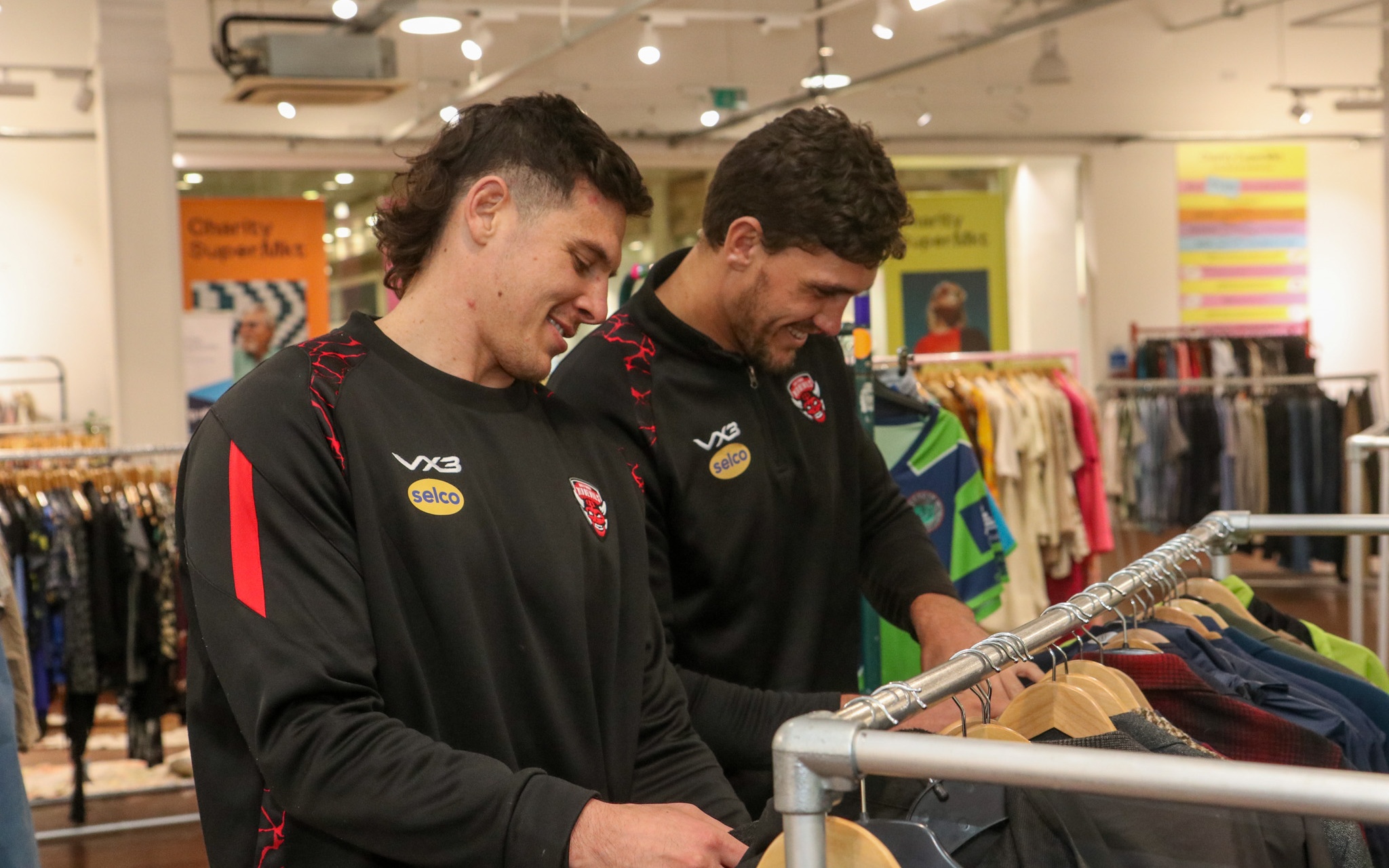 Salford Red Devils donate club kits to Charity Super.Mkt shop in Media City