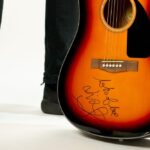Liam Fray is giving away a signed guitar to help raise money for a local school