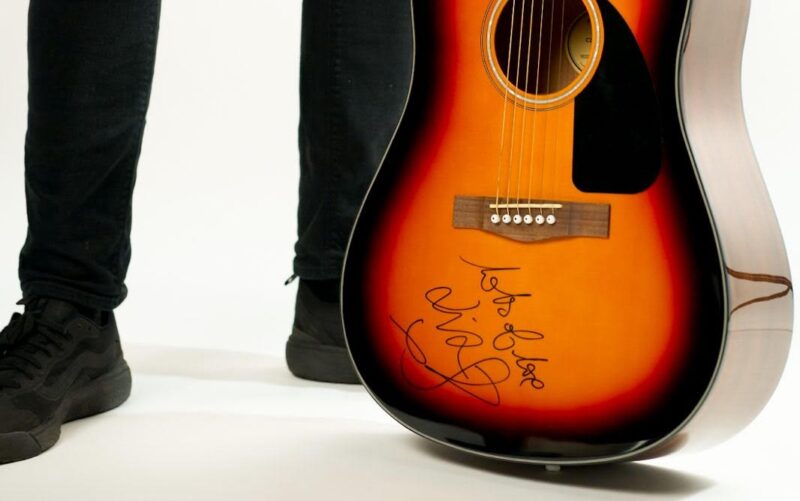 Liam Fray is giving away a signed guitar to help raise money for a local school