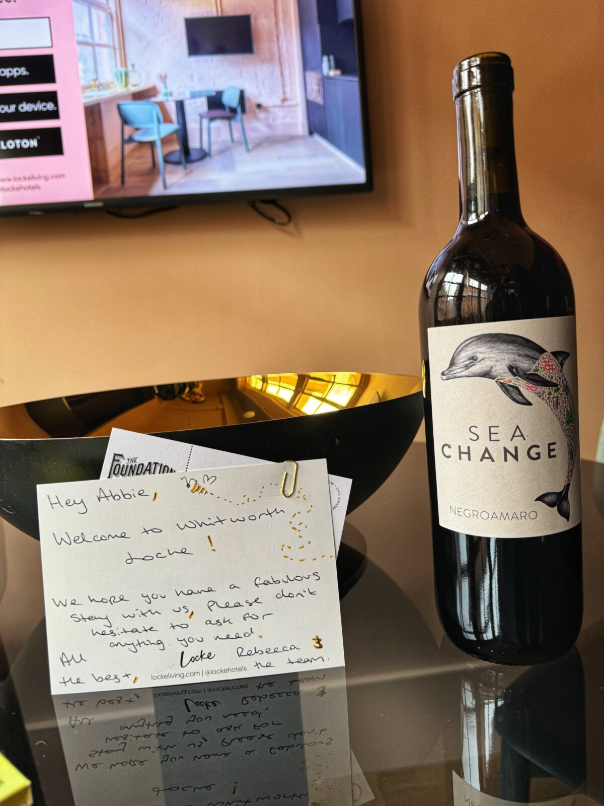 Hand-written note with bottle of red wine. 