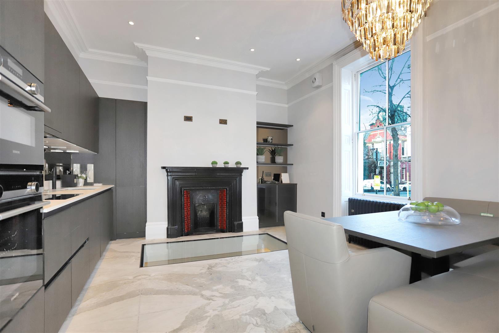 A contemporary kitchen with original fireplace inside a Greater Manchester townhouse