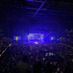 Noah Kahan performing on stage infront of thousands of people at co-op live in Manchester