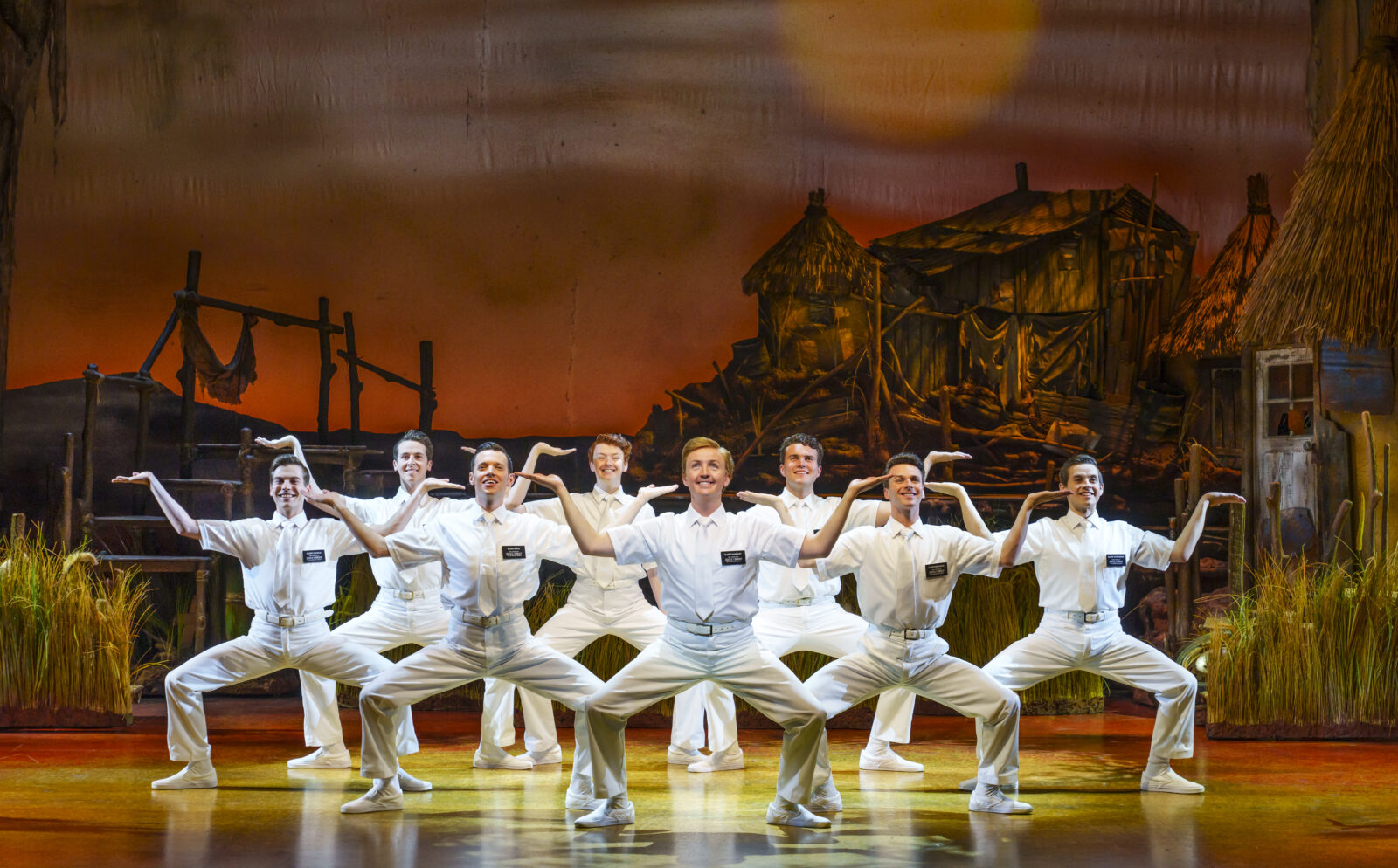 The ensemble of The Book of Mormon performing a dance number. 