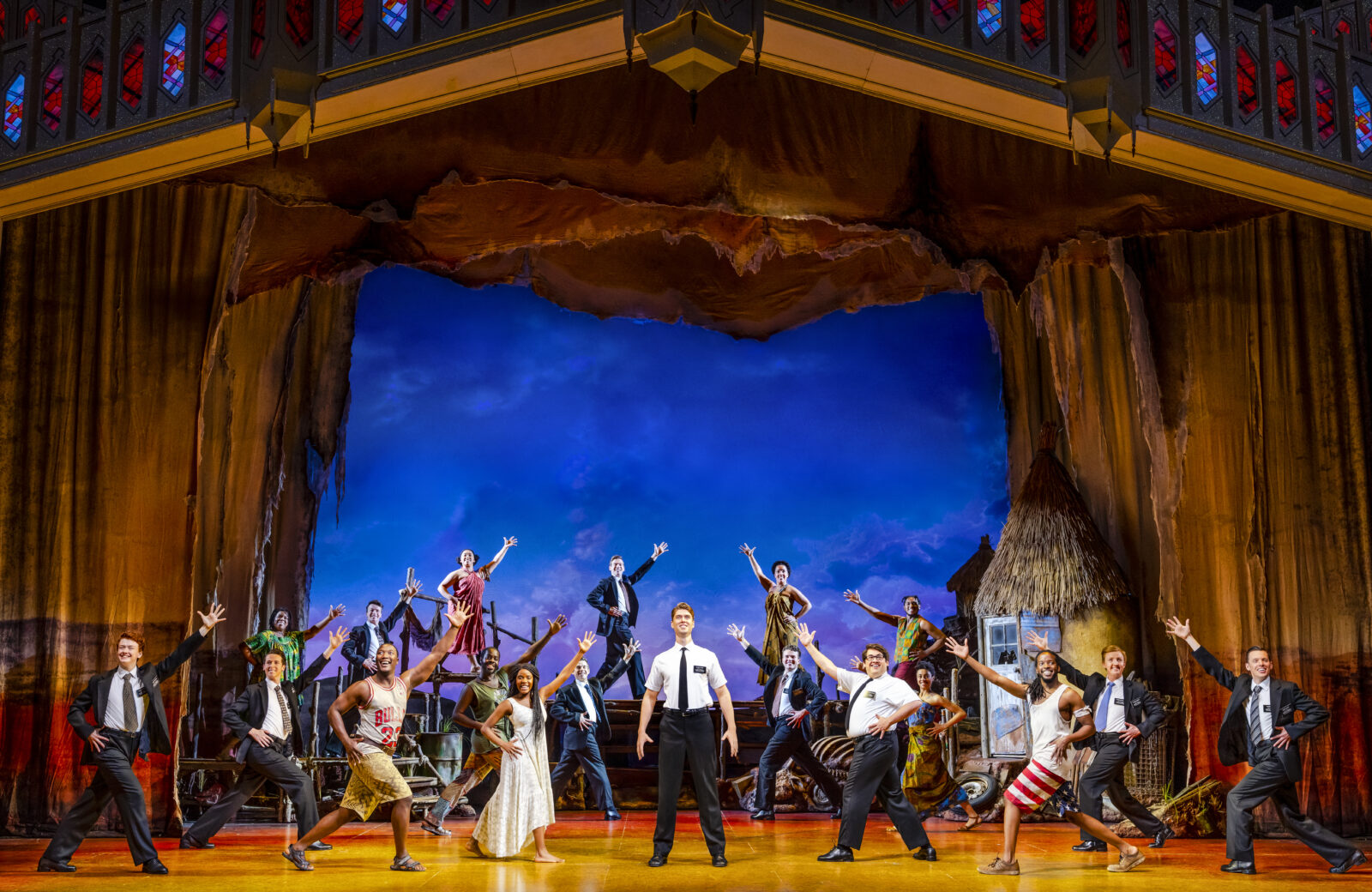 The full cast of the Book of Mormon on stage at Palace Theatre in Manchester 