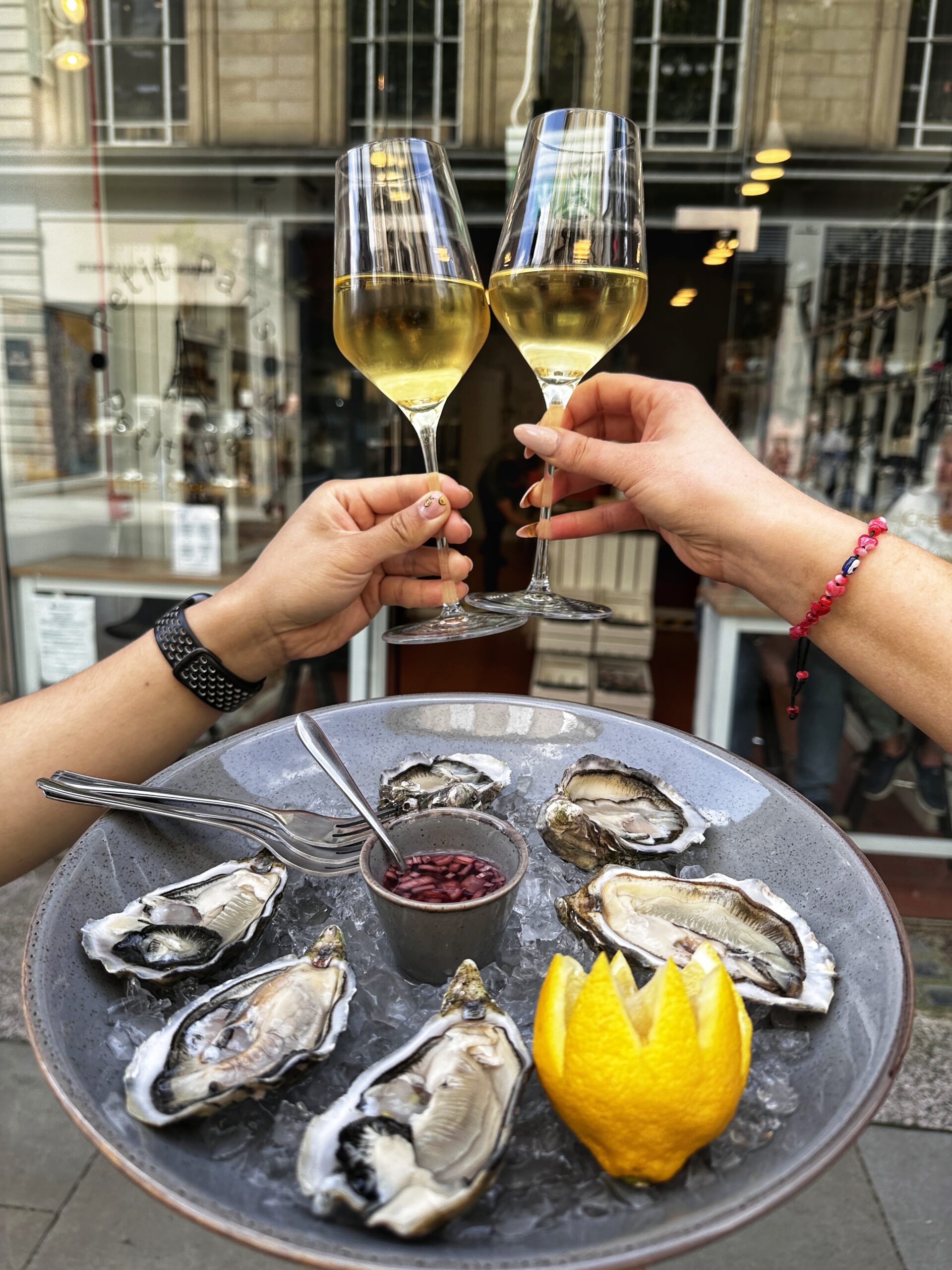 Oysters and wine at Petit Paris. Credit: The Manc Group