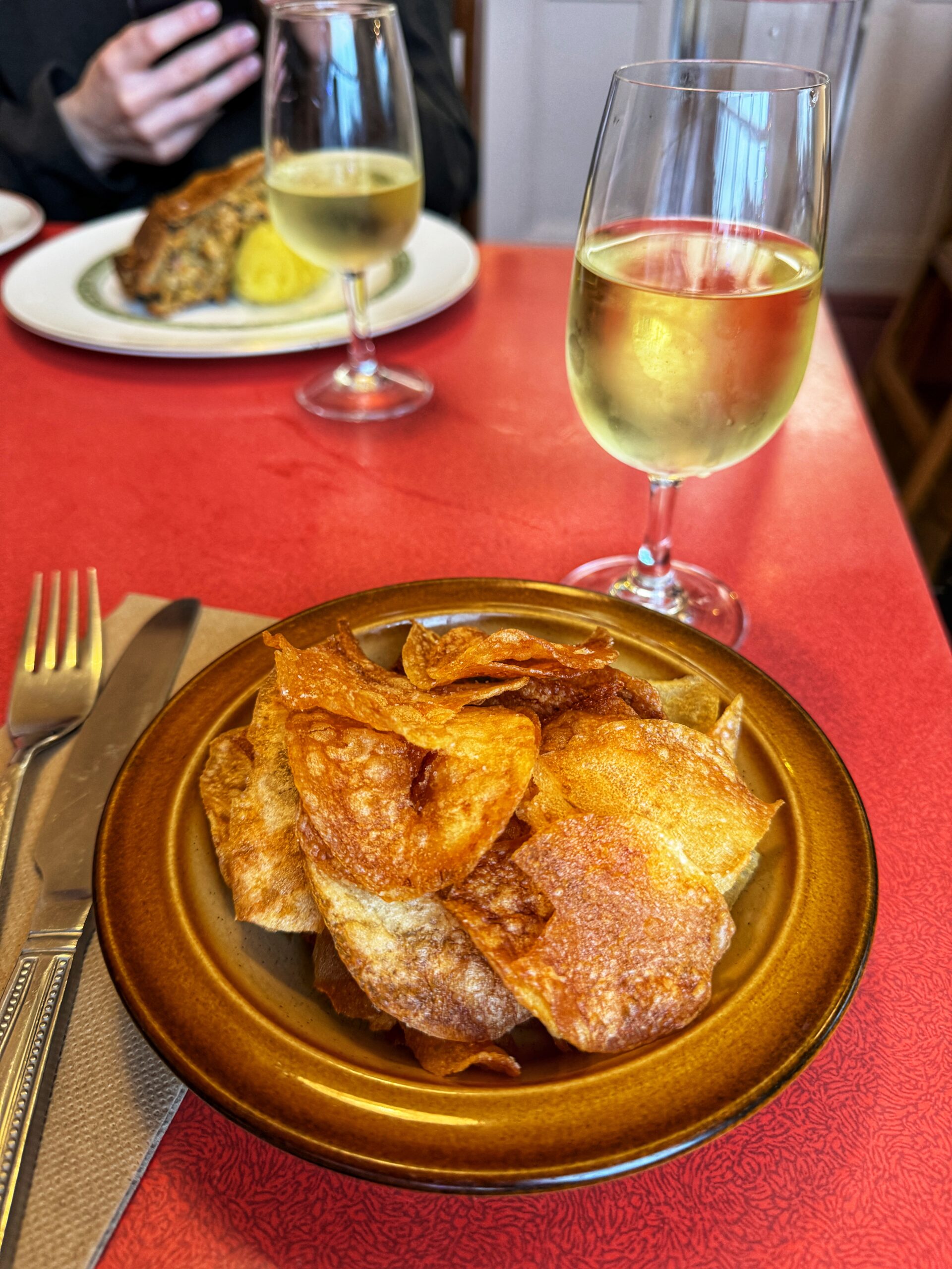 Homemade crisps and a glass of wine. Credit: The Manc Group