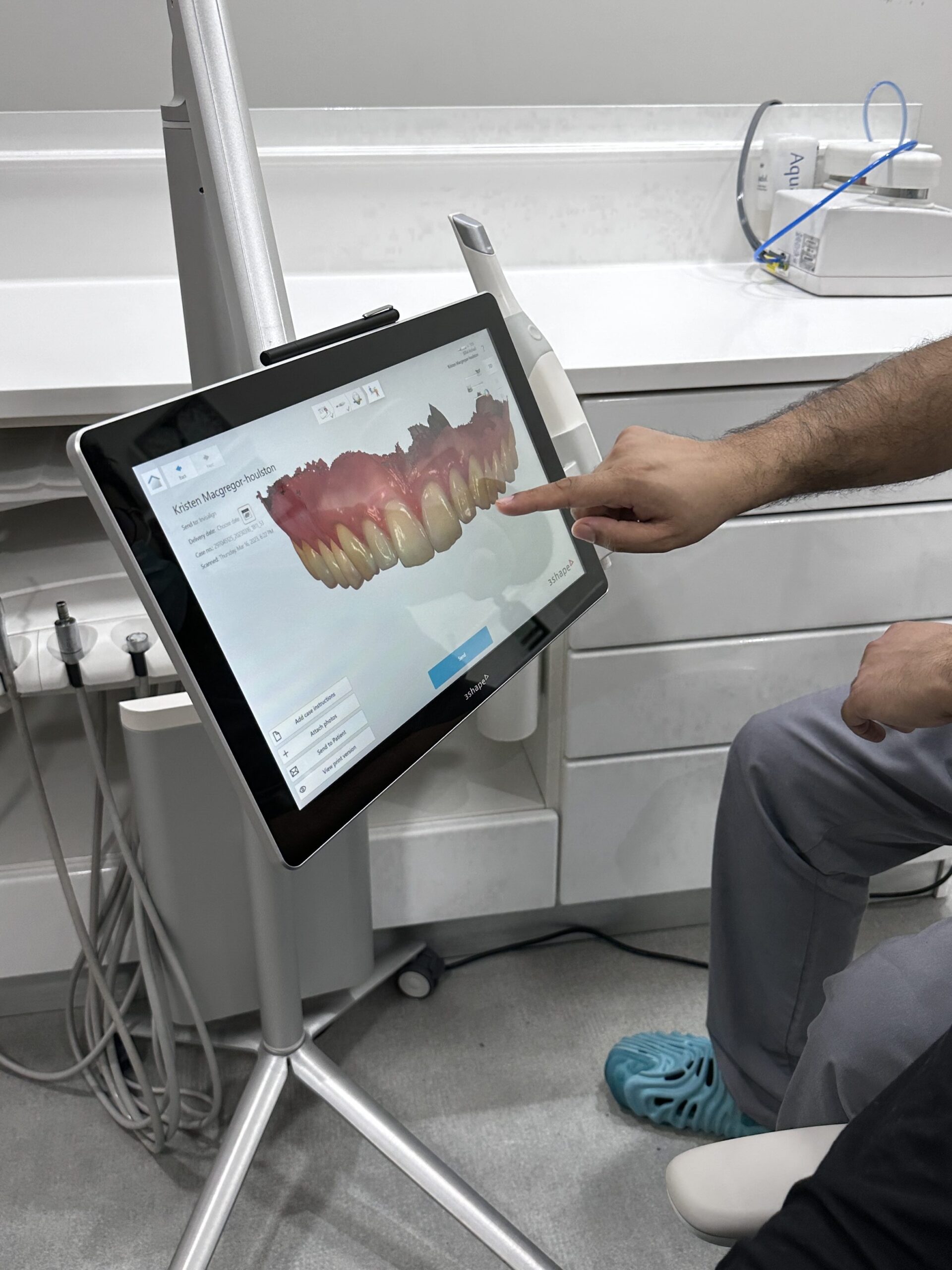 Dr Bilal taking a look at Kris' teeth during an appointment at Rüh Dental.