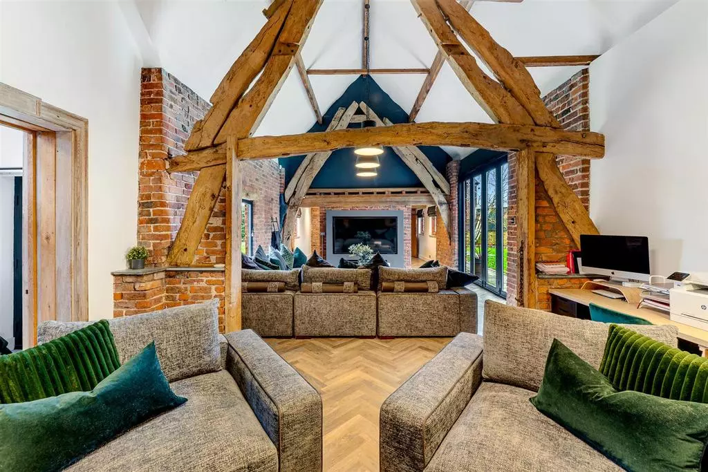 The snug area just behind the main living room, separated by the gorgeous wooden beams.
