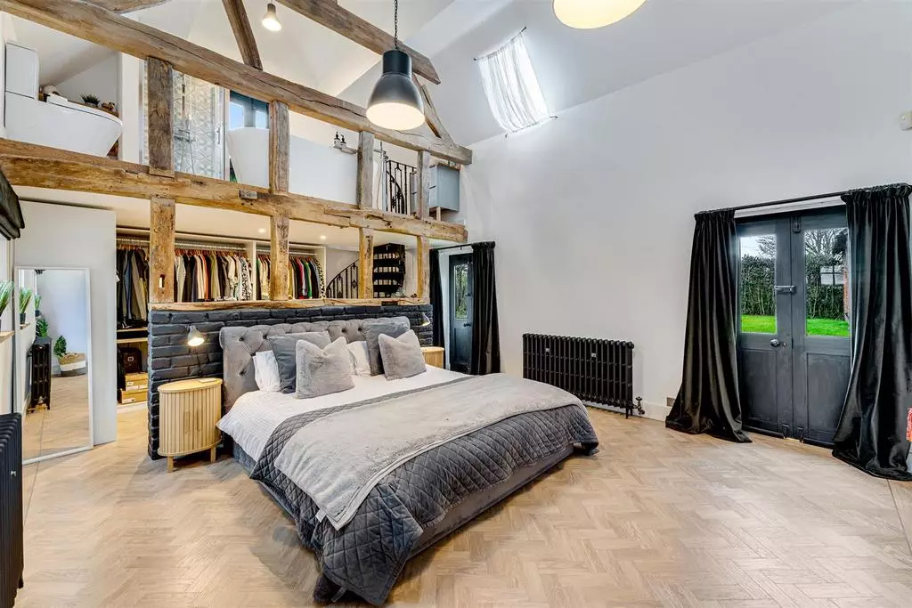 The main bedroom of the barn conversion with above mezzanine en-suite.