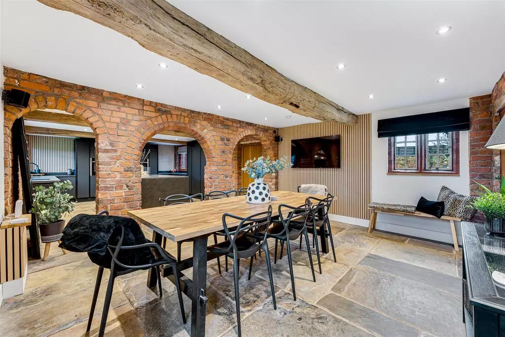 The dining room separated by that quirky three-arch brick wall.