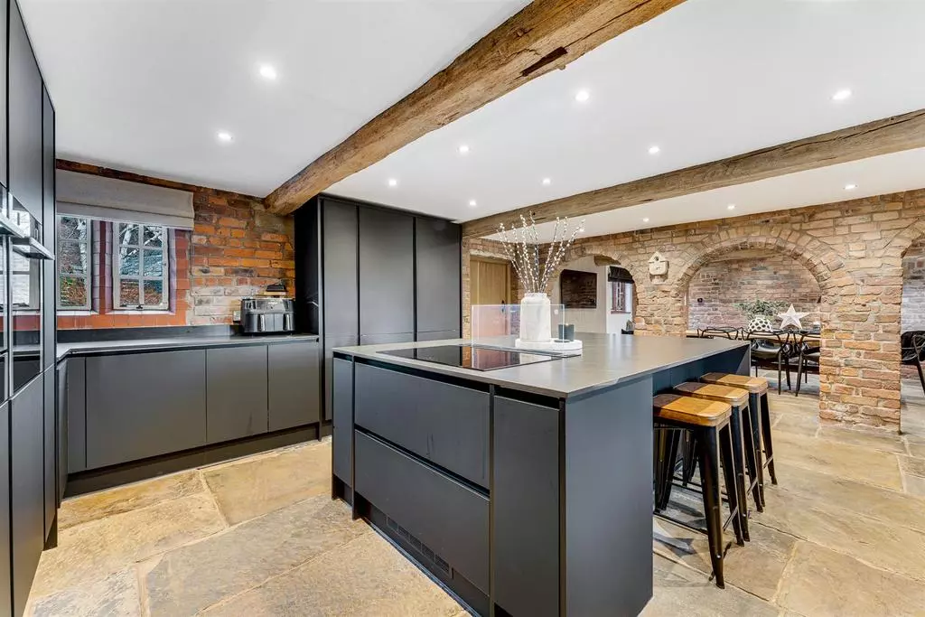 The minimalistic kitchen with accompanying island and breakfast bar.