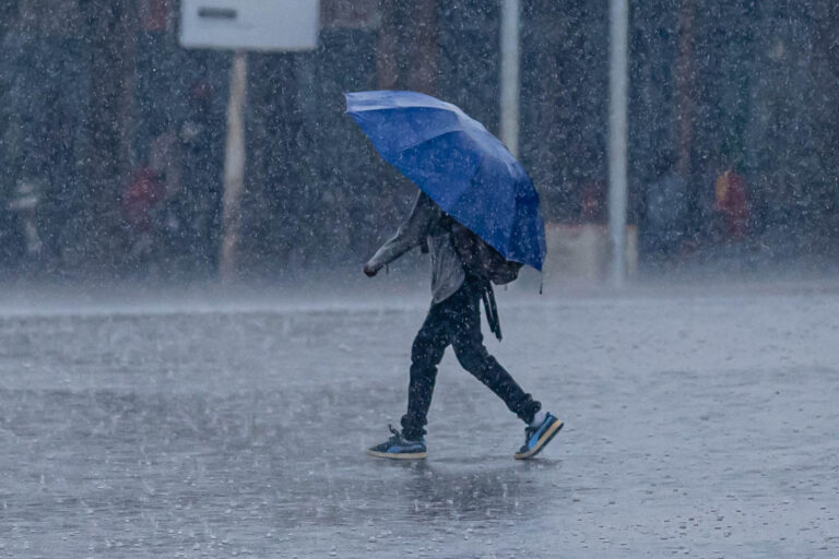 Man walking in rain