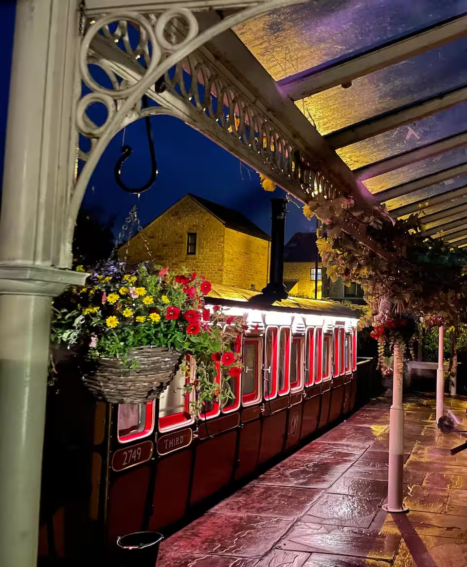 The converted train carriage Airbnb stands in an old train station