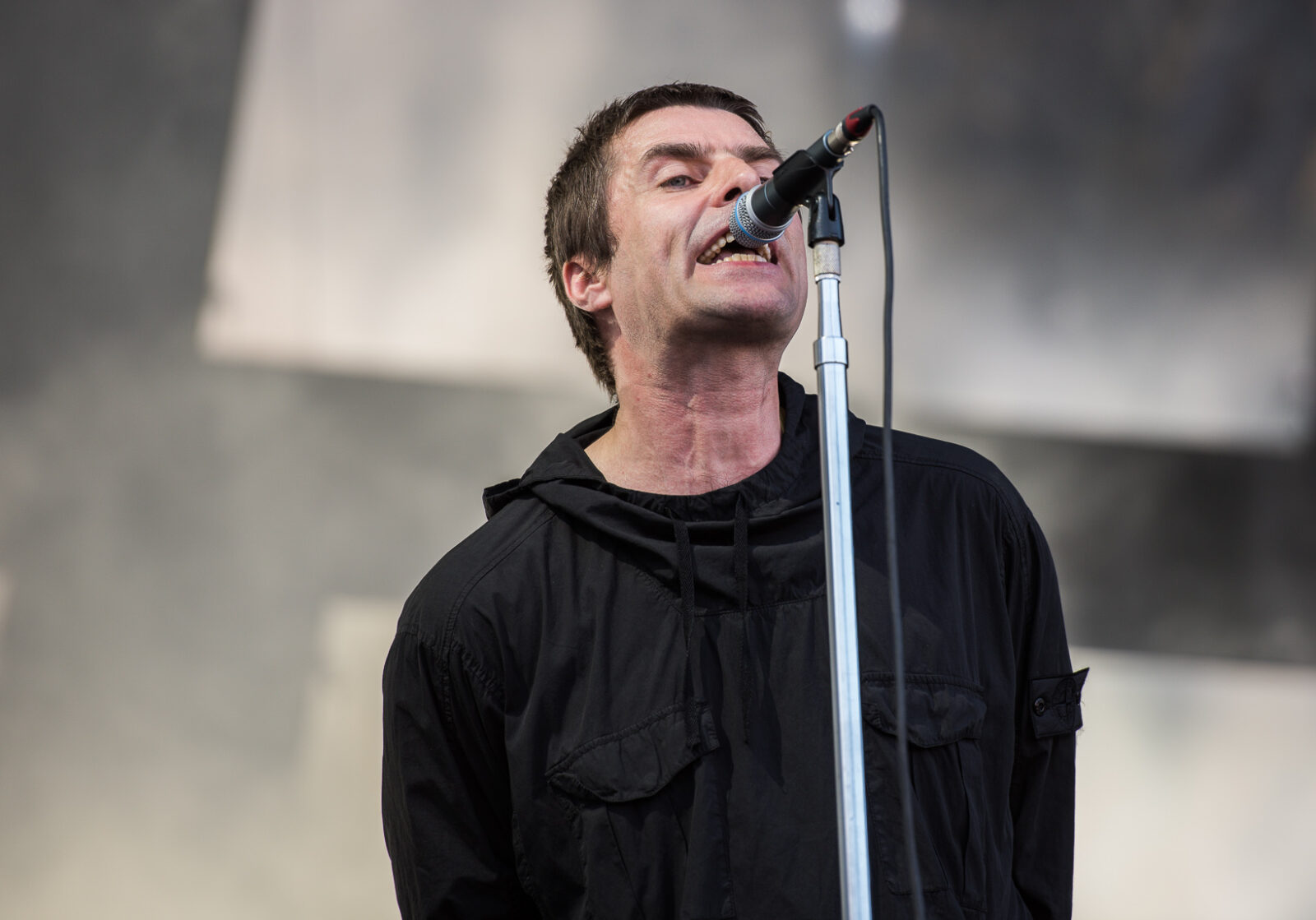 Liam Gallagher singing on stage