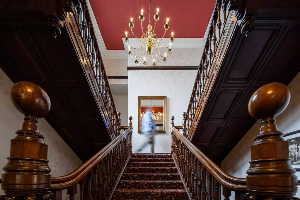 The grand staircase and one of ten bedrooms inside this Victorian mansion near Greater Manchester  / Credit: On The Market