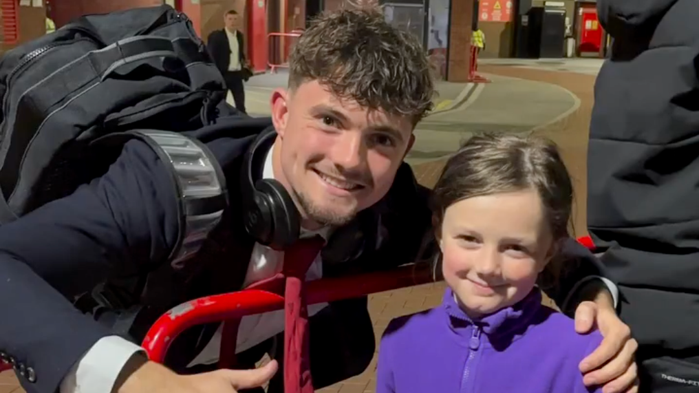 Man United youth academy player James Ovary gives boots to young fan