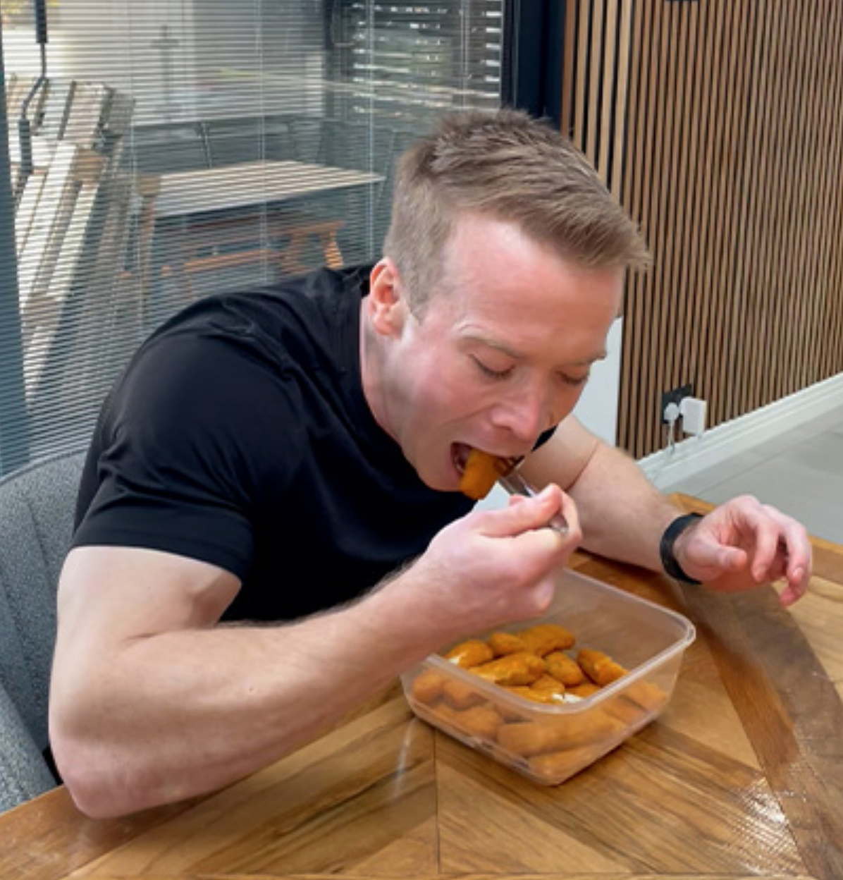 Man eating fish fingers