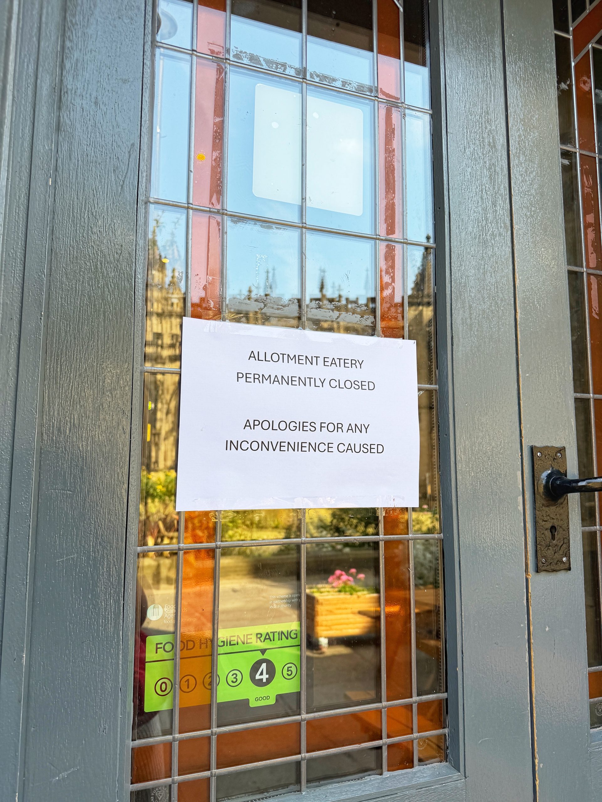 Signs in the door of Allotment Manchester